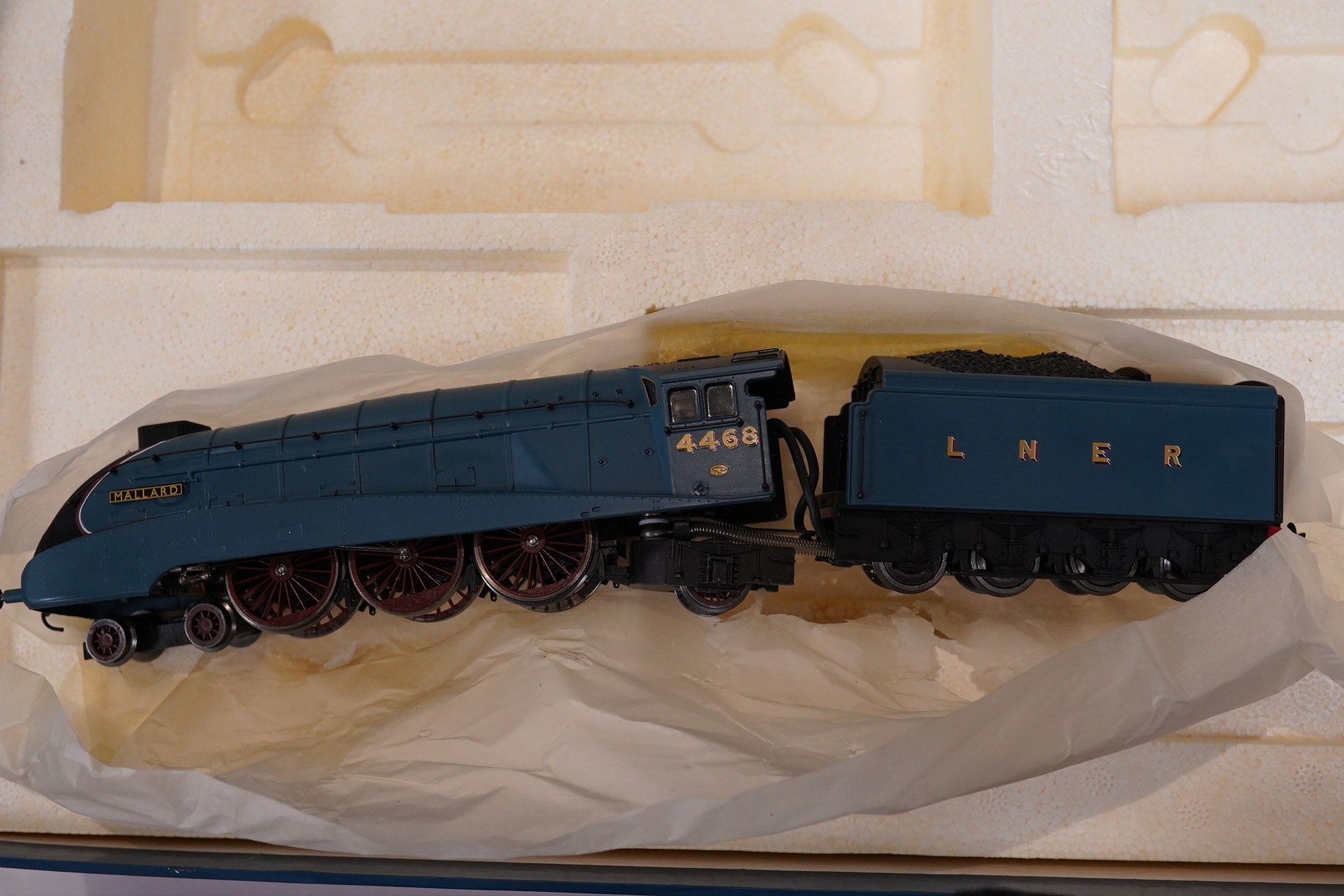 A boxed Hornby Hobbies 00 gauge railway live steam train set, comprising of an LNER Class A4 locomotive, Mallard, a quantity of track sections, controllers, and other accessories. Condition - good, appears unused with in